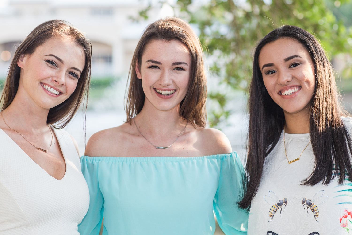 Three Women wearing Theta Jewellery hand stamped necklaces