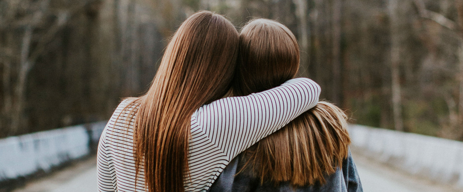 Two friends hugging