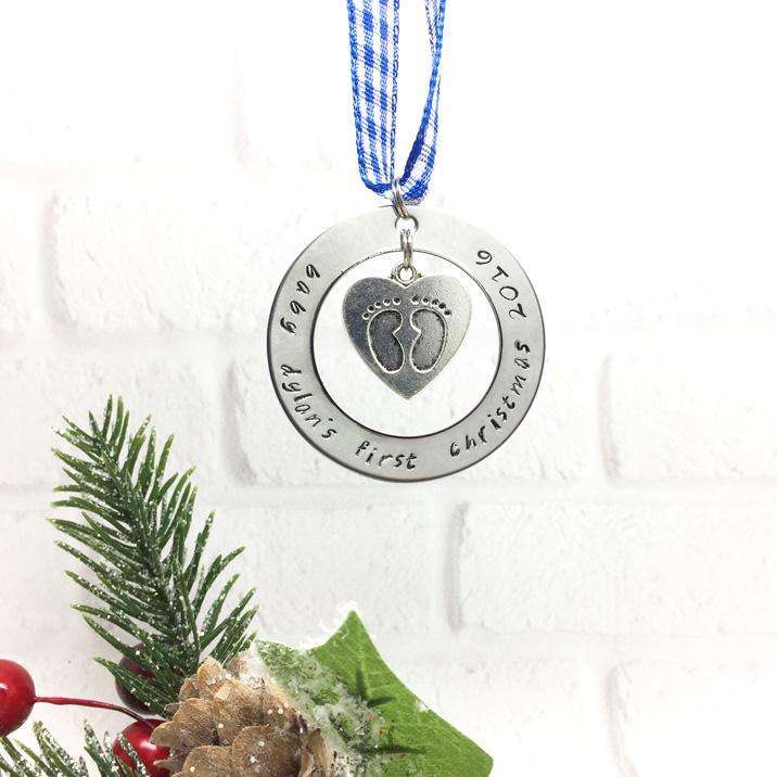 A baby's first Christmas decoration hanging on a blue ribbon